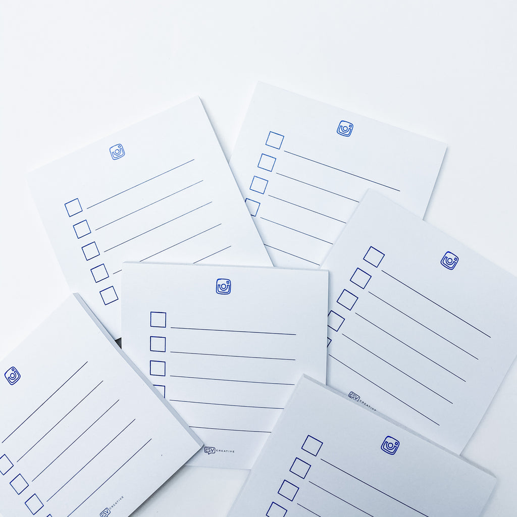 Several ESV Creative Social Strategy Sticky Notes with checkboxes arranged in columns, bearing a logo at the top, scattered across a white surface.